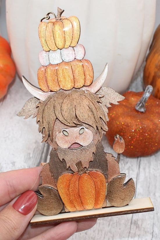 Highland Cow with Stack of Pumpkins