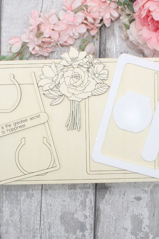 Unpainted floral vase frame craft kit pieces including wooden elements and acrylic frame