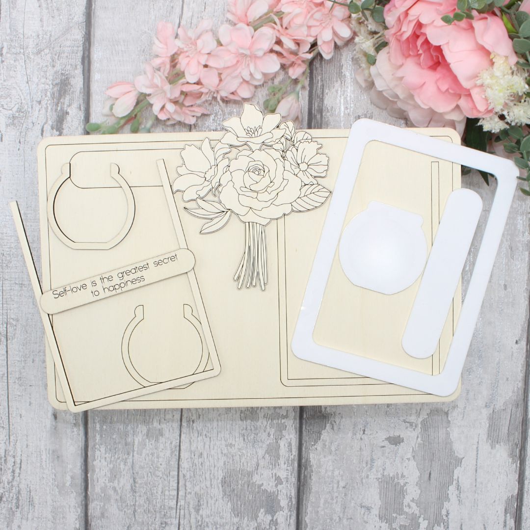 Unpainted floral vase frame craft kit pieces including wooden elements and acrylic frame