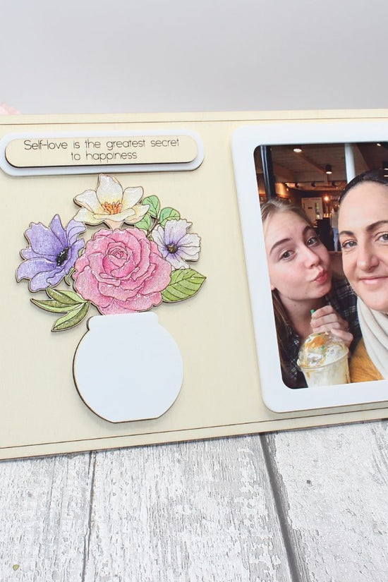 Completed floral vase frame craft kit with hand-painted flowers and personal photo displayed
