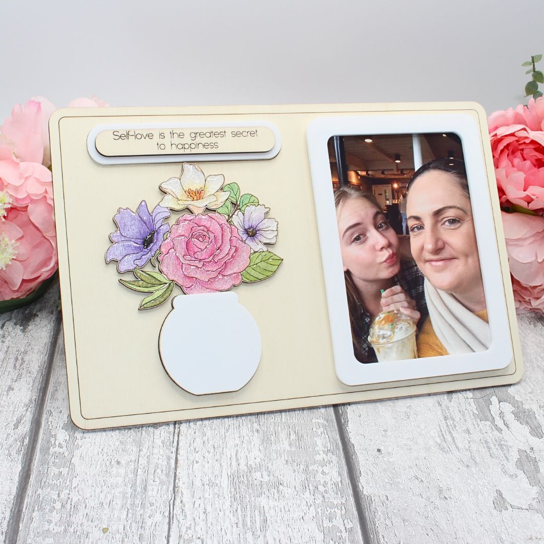 Completed floral vase frame craft kit with hand-painted flowers and personal photo displayed